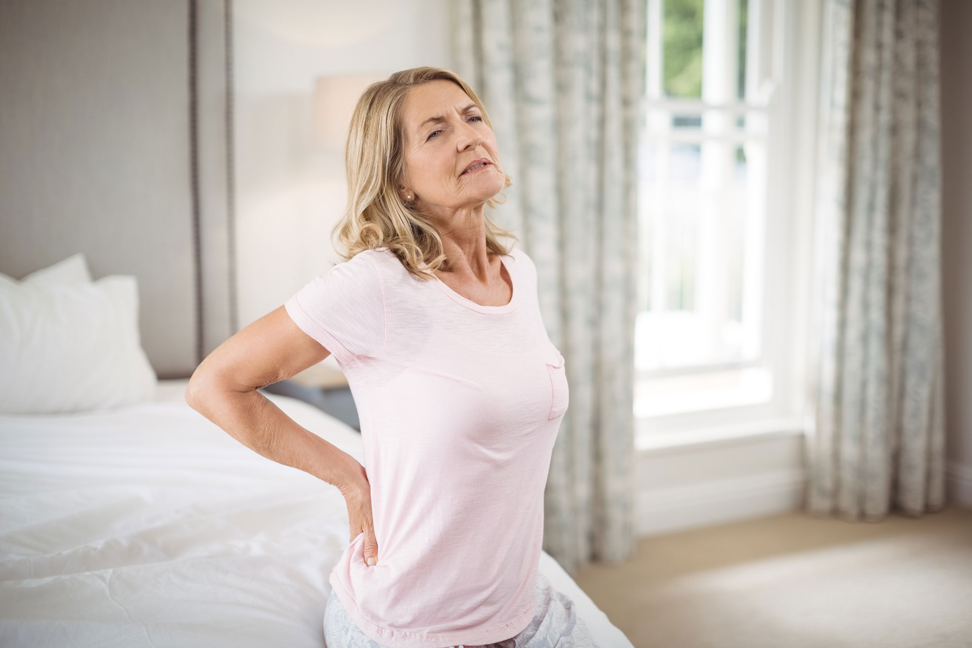 senior woman having back pain in bedroom 2021 08 28 17 56 27 utc